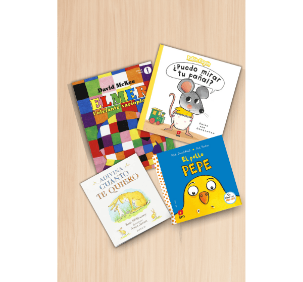 Los Mejores libros para niños de 3 años. Cuatro libros infantiles recomendados para niños de 3 años sobre una superficie de madera: Elmer, Adivina cuánto te quiero, El pollo Pepe y ¿Puedo mirar tu pañal?.